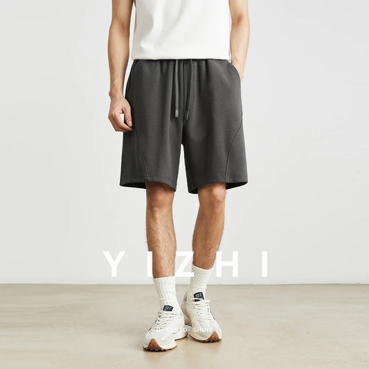 Novedad de verano para hombre, pantalones cortos informales americanos, pantalones rectos sueltos de cinco puntos, pantalones deportivos microelásticos con bolsillo y cordón de Color sólido